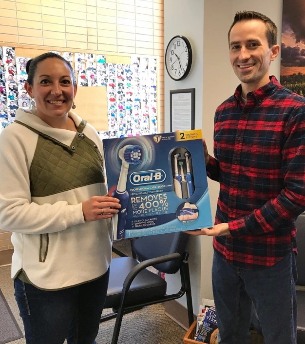 Patient receiving an Oral-B electric toothbrush gift at Kaukauna Family Dentistry